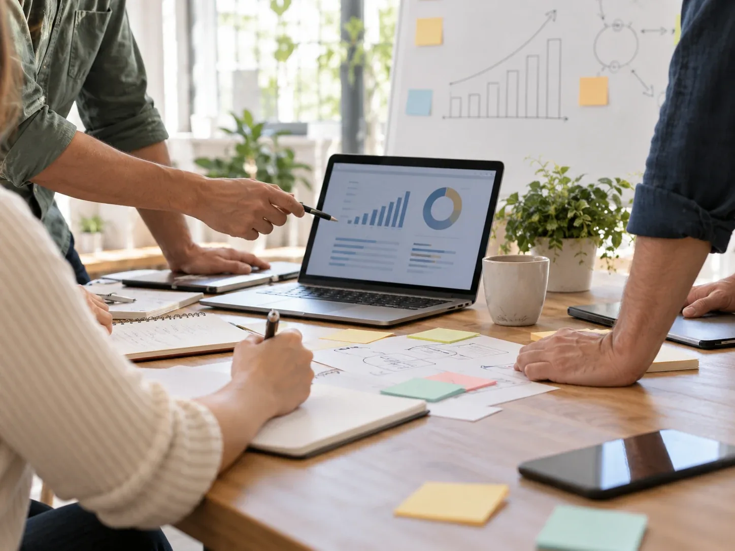 A small business technology team planning work around a laptop
